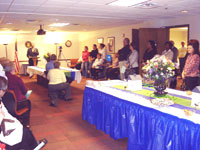 [Photo 1: Employees and guests gathered in the Conference Room to hear the Grand Opening speakers]