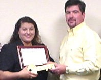 [Photo 2: Ms. Guerra received a key to her new home]