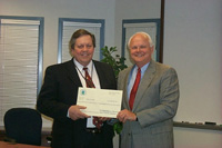 [Photo of Mr. Walker receiving a check from Field Office Director]