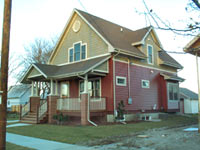 [Photo 1: A 2-bedroom single family home with brown roof and burgundy-colored exterior]