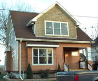 [Photo 3: A 3-bedroom single family home with brown roof and light brown-colored exterior]