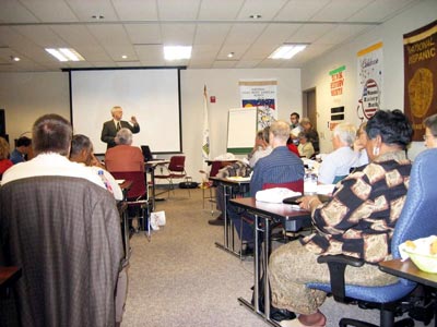 [Photo 1: Field Office Director Del Reynolds welcomed the grantees and discussed current HUD initiatives.]