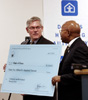 [Photo:  Congressman Pete Sessions receiving a check from Secretary Jackson]