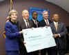 [Photo: Secretary Jackson and U.S. Senator Hutchison holding large check]