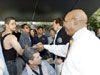 [Photo: Secretary Jackson and Governor Arnold Schwarzenegger shaking hands with citizens.]