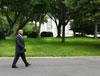 [Photo: Secretary Jackson walks to the White House.]