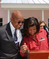 [Photo: Secretary Jackson comforts excited new homeowner in Miami, Florida.]
