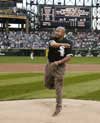 [Photo: Secretary Jackson throwing first pitch]