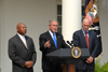 [Photo: HUD Secretary Jackson (left), President Bush (center), and Henry Paulson Jr. (right)]